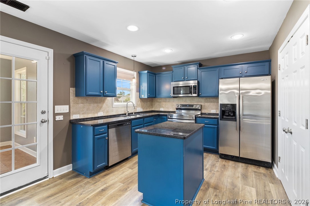 269 Declaration Drive Raeford, NC 28376 - Photo 15 of 44 a kitchen with stainless steel appliances granite countertop a refrigerator a sink a stove a microwave and island