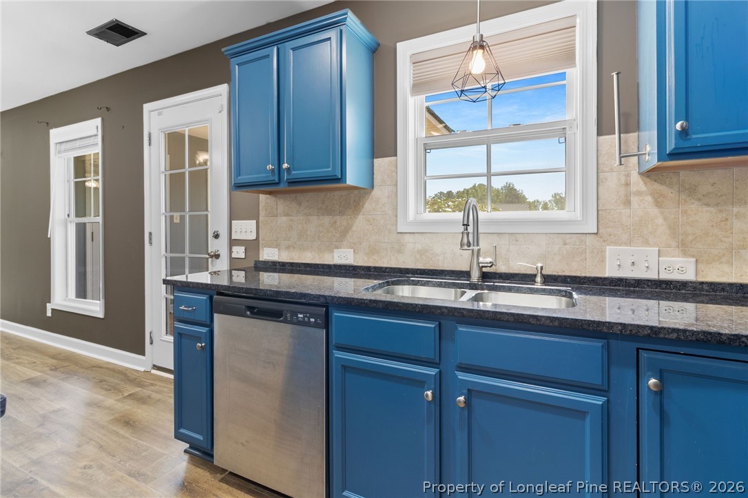 269 Declaration Drive Raeford, NC 28376 - Photo 17 of 44 a kitchen with stainless steel appliances granite countertop wooden cabinets a sink and dishwasher with wooden floor
