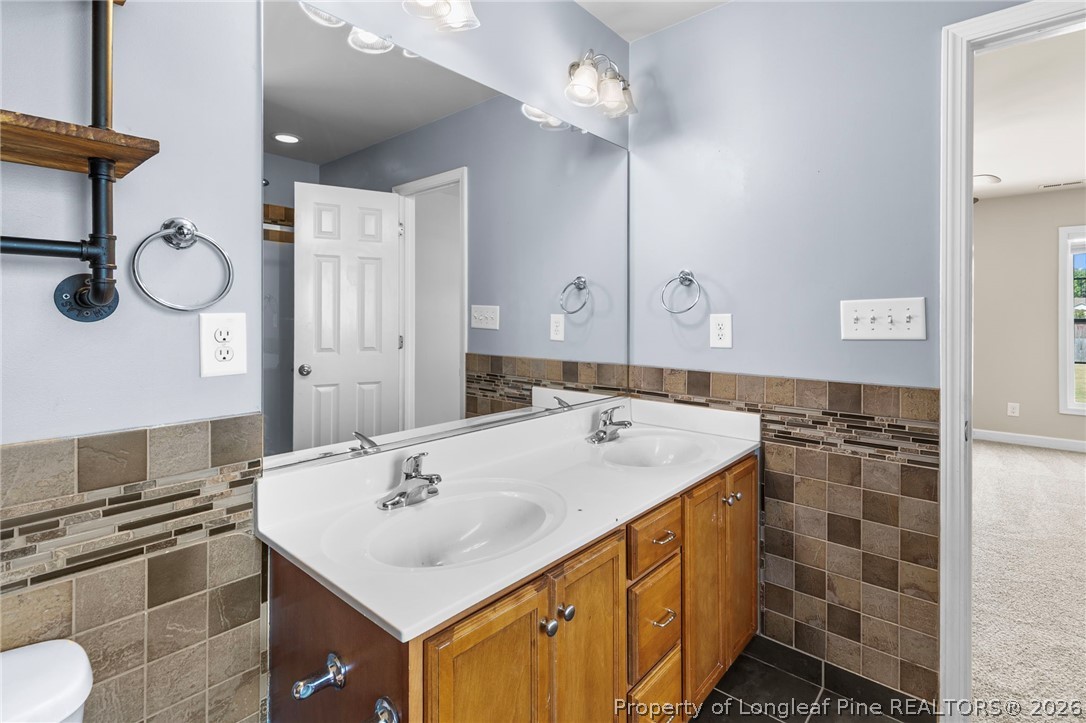 269 Declaration Drive Raeford, NC 28376 - Photo 24 of 44 a bathroom with a sink toilet and shower
