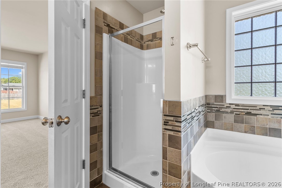 269 Declaration Drive Raeford, NC 28376 - Photo 26 of 44 a bathroom with a bathtub and a shower