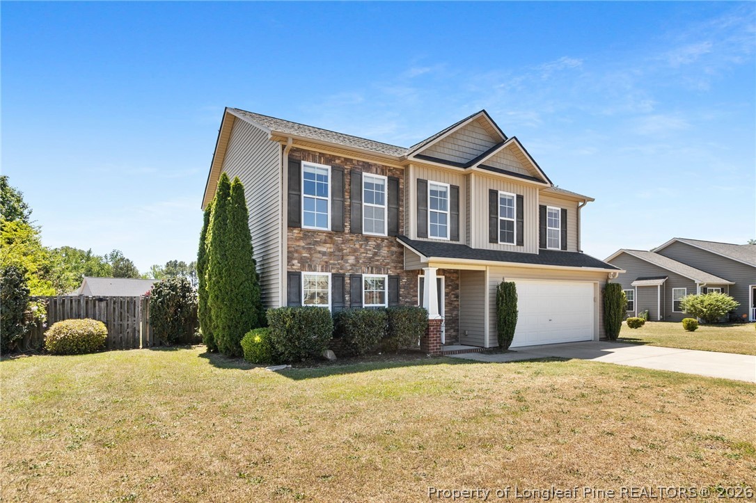 269 Declaration Drive Raeford, NC 28376 - Photo 3 of 44 a front view of a house with a yard and garage
