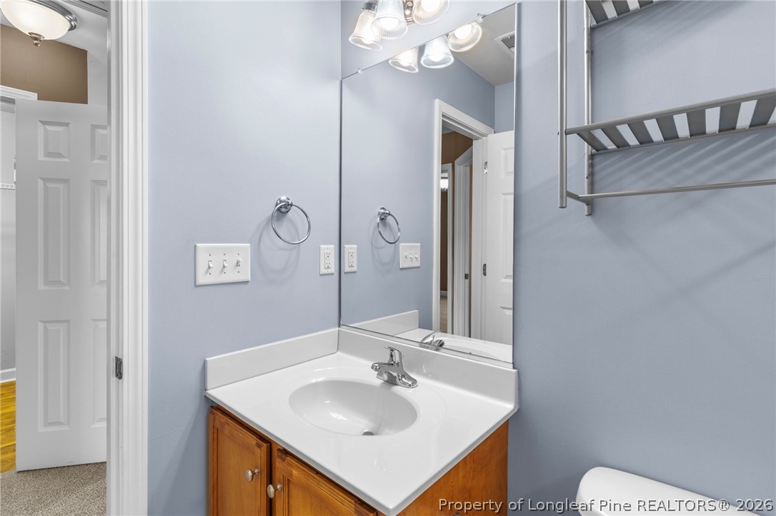 269 Declaration Drive Raeford, NC 28376 - Photo 33 of 44 a bathroom with a sink a mirror and a toilet