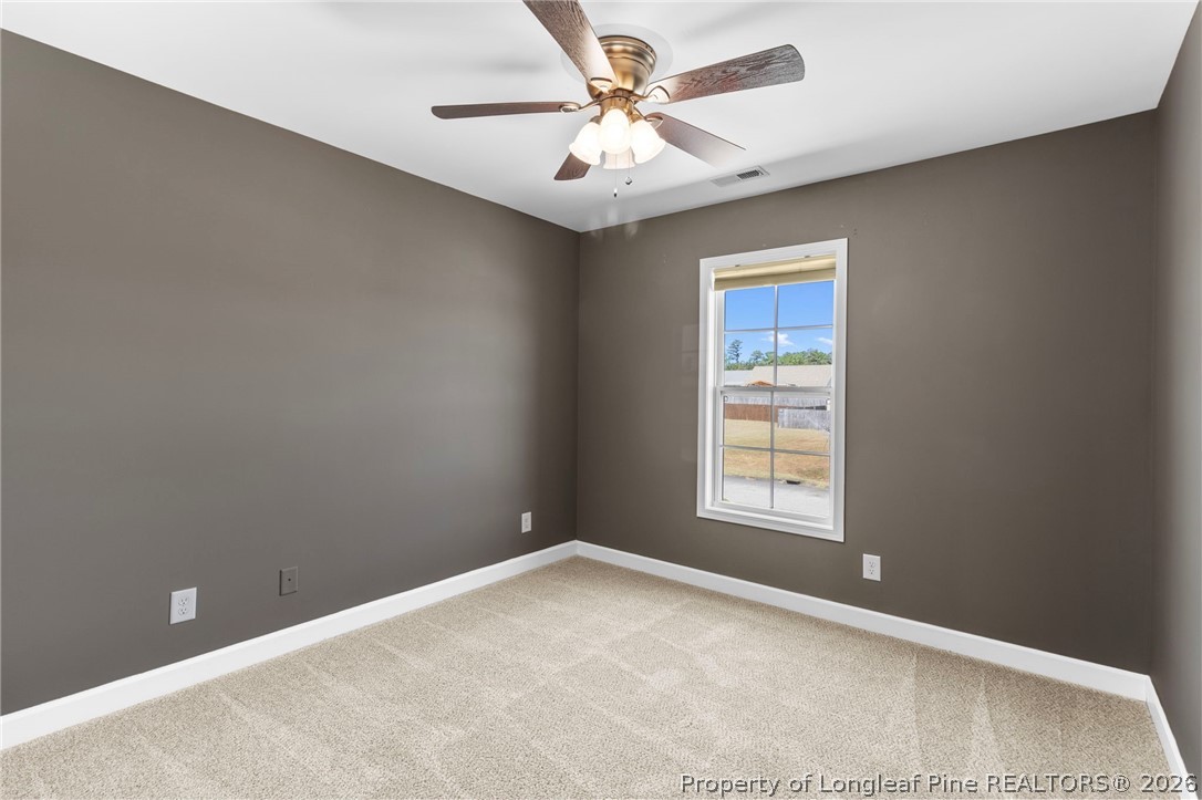 269 Declaration Drive Raeford, NC 28376 - Photo 34 of 44 an empty room with windows and ceiling fan