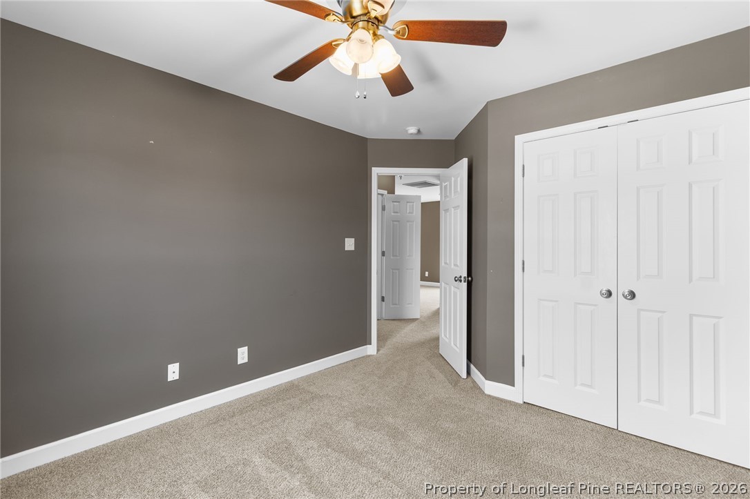 269 Declaration Drive Raeford, NC 28376 - Photo 35 of 44 an empty room with chandelier fan and windows