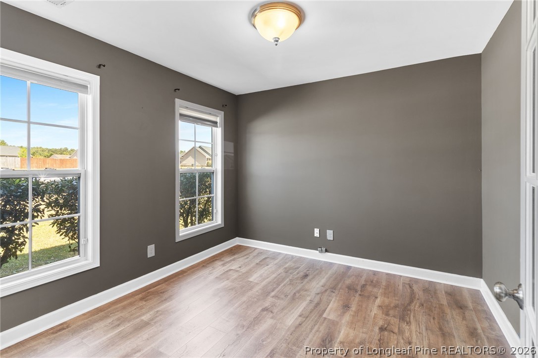 269 Declaration Drive Raeford, NC 28376 - Photo 6 of 44 a view of an empty room with wooden floor and a window