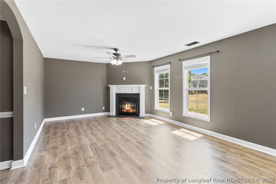 269 Declaration Drive Raeford, NC 28376 - Photo 10 of 44 an empty room with windows and fireplace