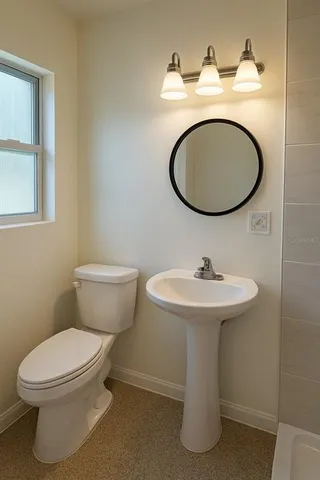 a bathroom with a toilet a sink and a mirror