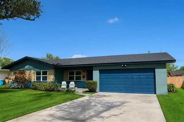 a front view of a house with a garden and yard
