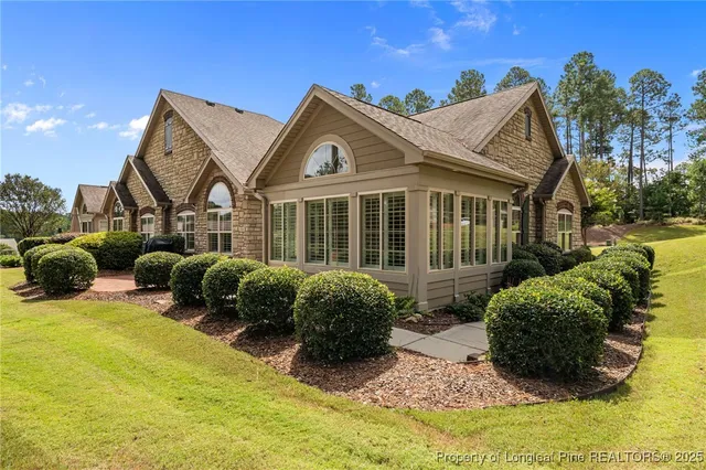 a view of a house with a big yard and potted plants