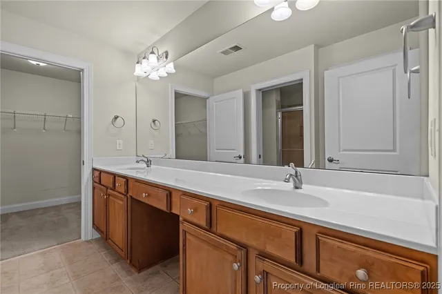 a bathroom with a double vanity sink and a mirror