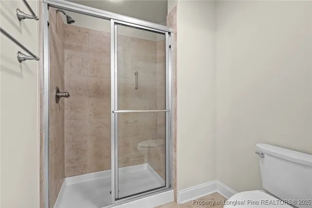 a bathroom with a shower and toilet