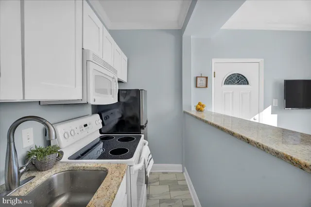 a kitchen with a microwave a stove and a sink