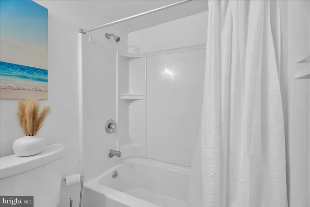 a bathroom with a tub and shower curtain
