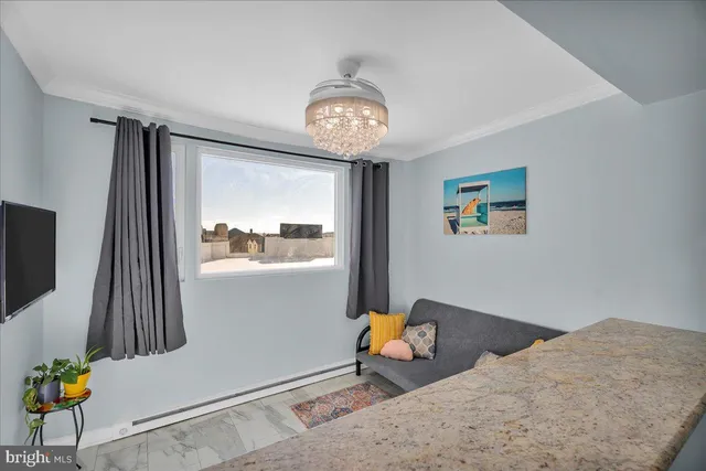 a view of dining room with wooden floor and a chandelier