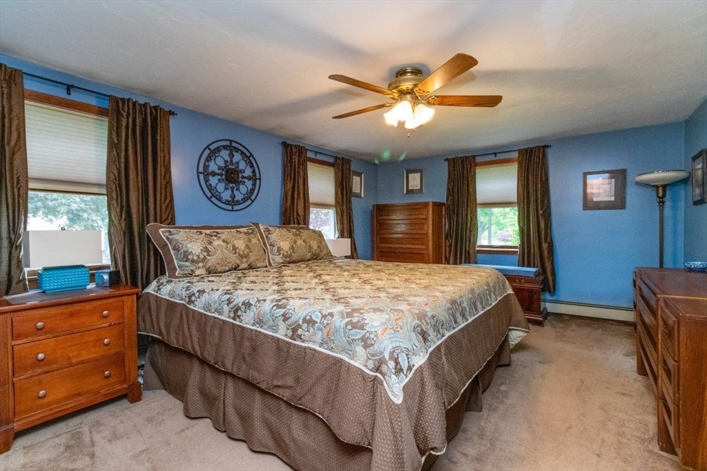 118 Bruce Road Walpole, MA 02081 - Photo 14 of 30 a bedroom with a large bed and a chandelier