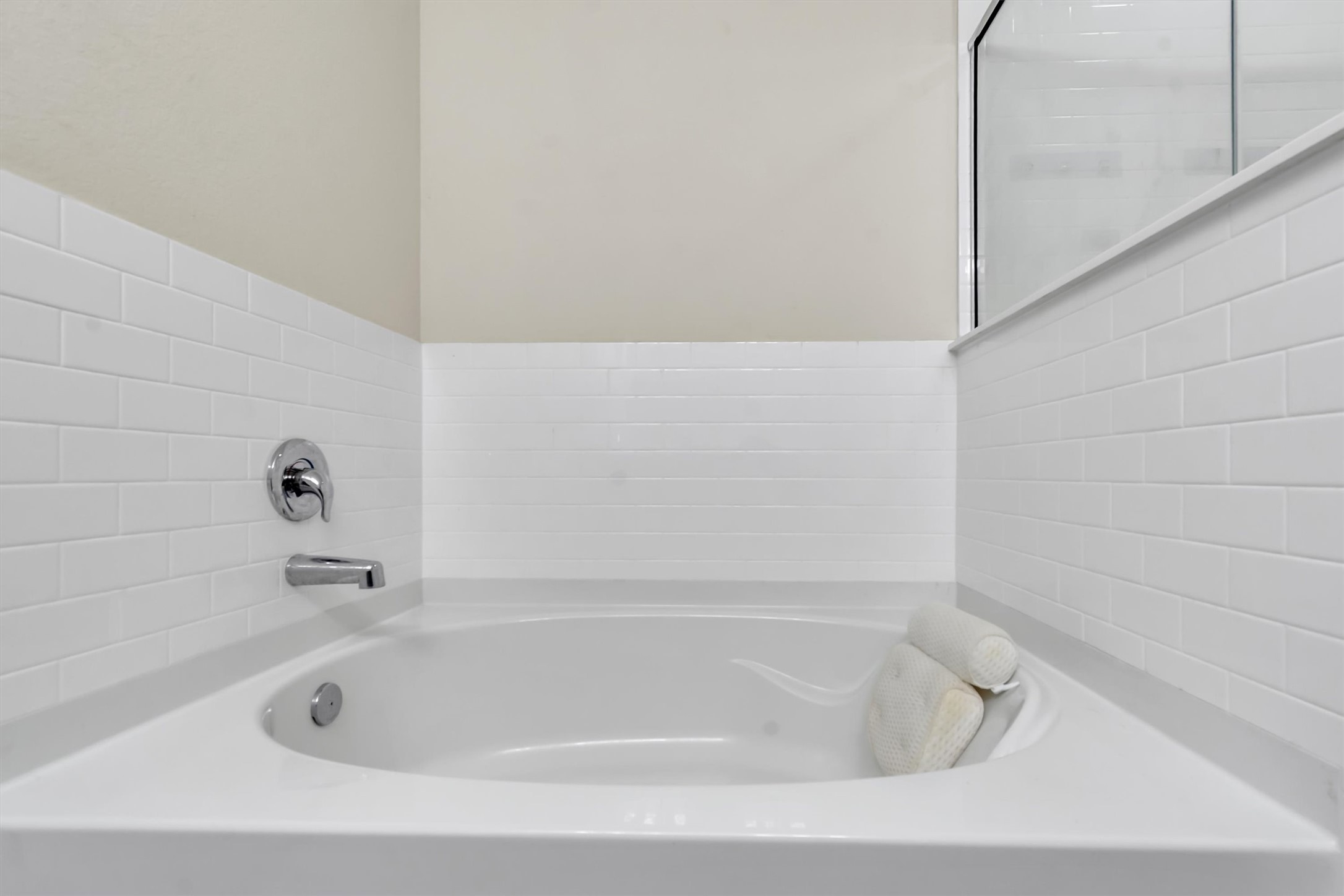 11701 Jackson Falls Way Manor, TX 78653 - Photo 19 of 40 Indulge in relaxation within this pristine bathroom's deep soaking tub, complete with clean white subway tile surround.