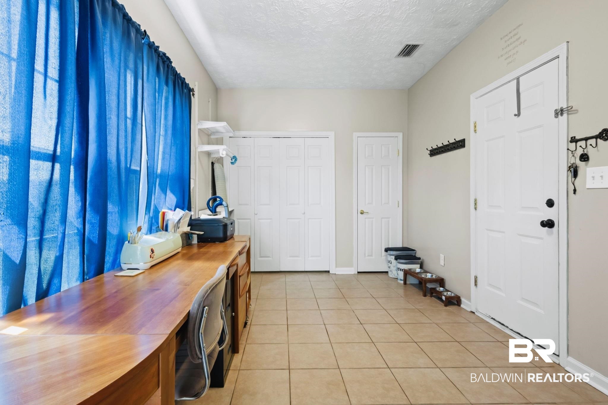 3820 Emerille Drive Foley, AL 36535 - Photo 14 of 24 Enter through the garage into this large space, perfect for a home office. Behind those closet doors on the left, you’ll find your laundry hookups.