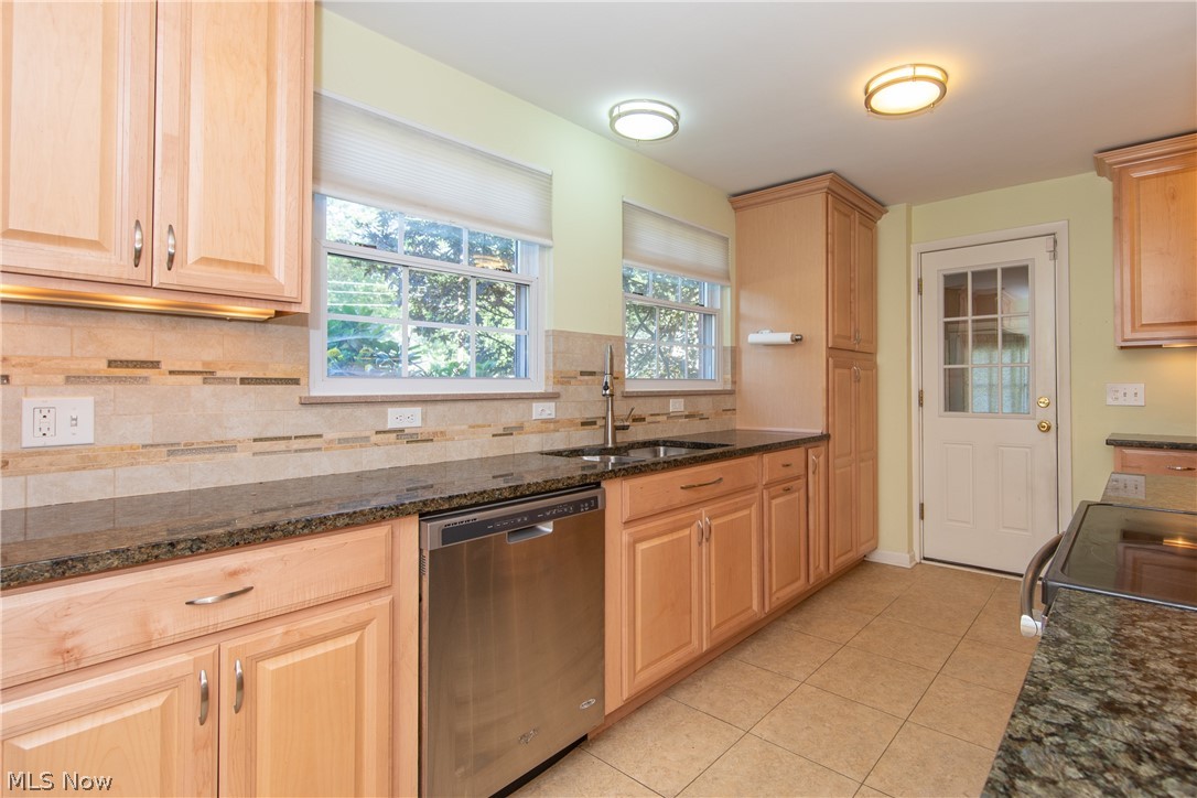 2046 Temblethurst Road South Euclid, OH 44121 - Photo 2 of 35 The remodeled Kitchen with black granite counters and natural wood cabinets. The glass pane door leads to the attached garage