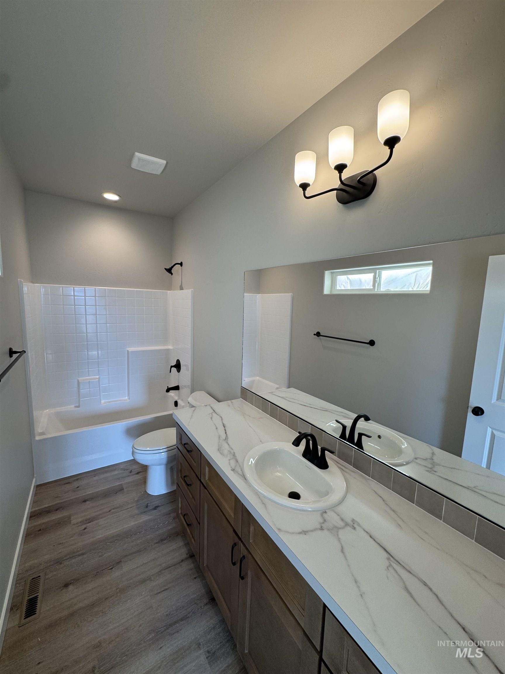 939 Quartz Road Kimberly, ID 83341 - Photo 11 of 18 Bathroom with shower / bathtub combination, vanity, and dark wood-style flooring