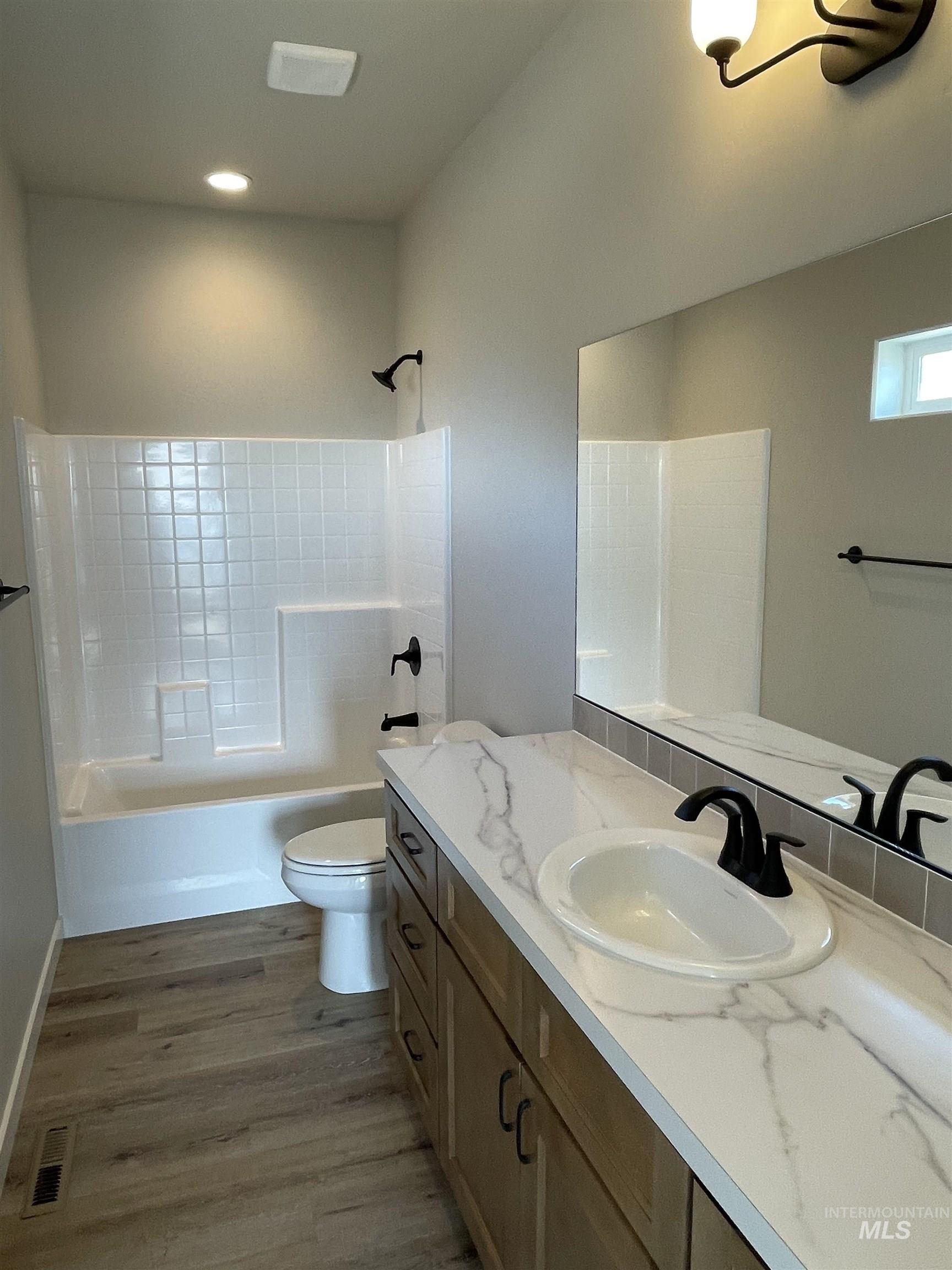 939 Quartz Road Kimberly, ID 83341 - Photo 12 of 18 Bathroom with vanity, dark wood-type flooring, and tub / shower combination