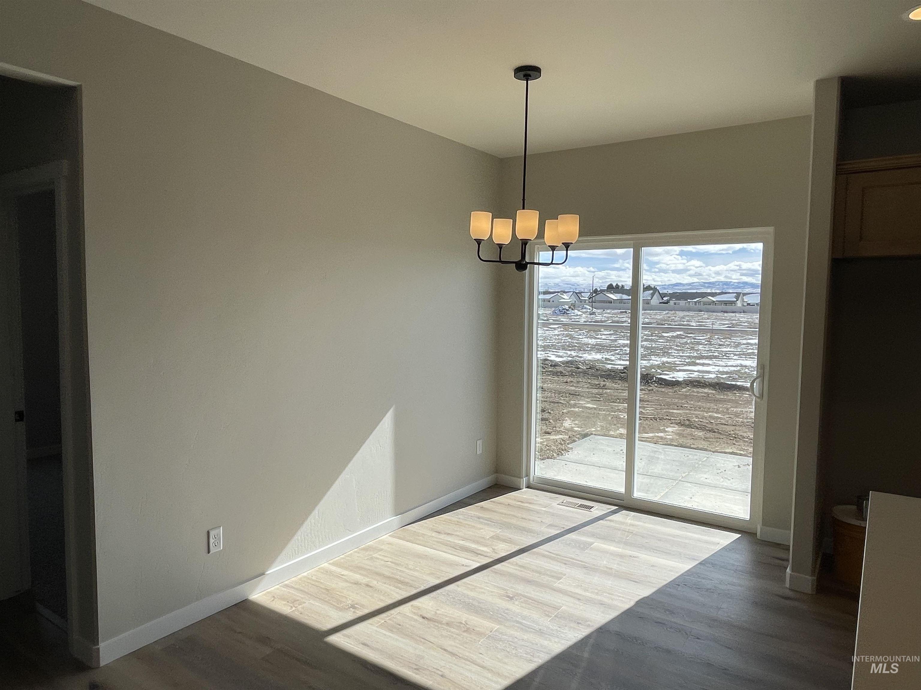 939 Quartz Road Kimberly, ID 83341 - Photo 13 of 18 Unfurnished dining area featuring suspended lighting and wood finished floors