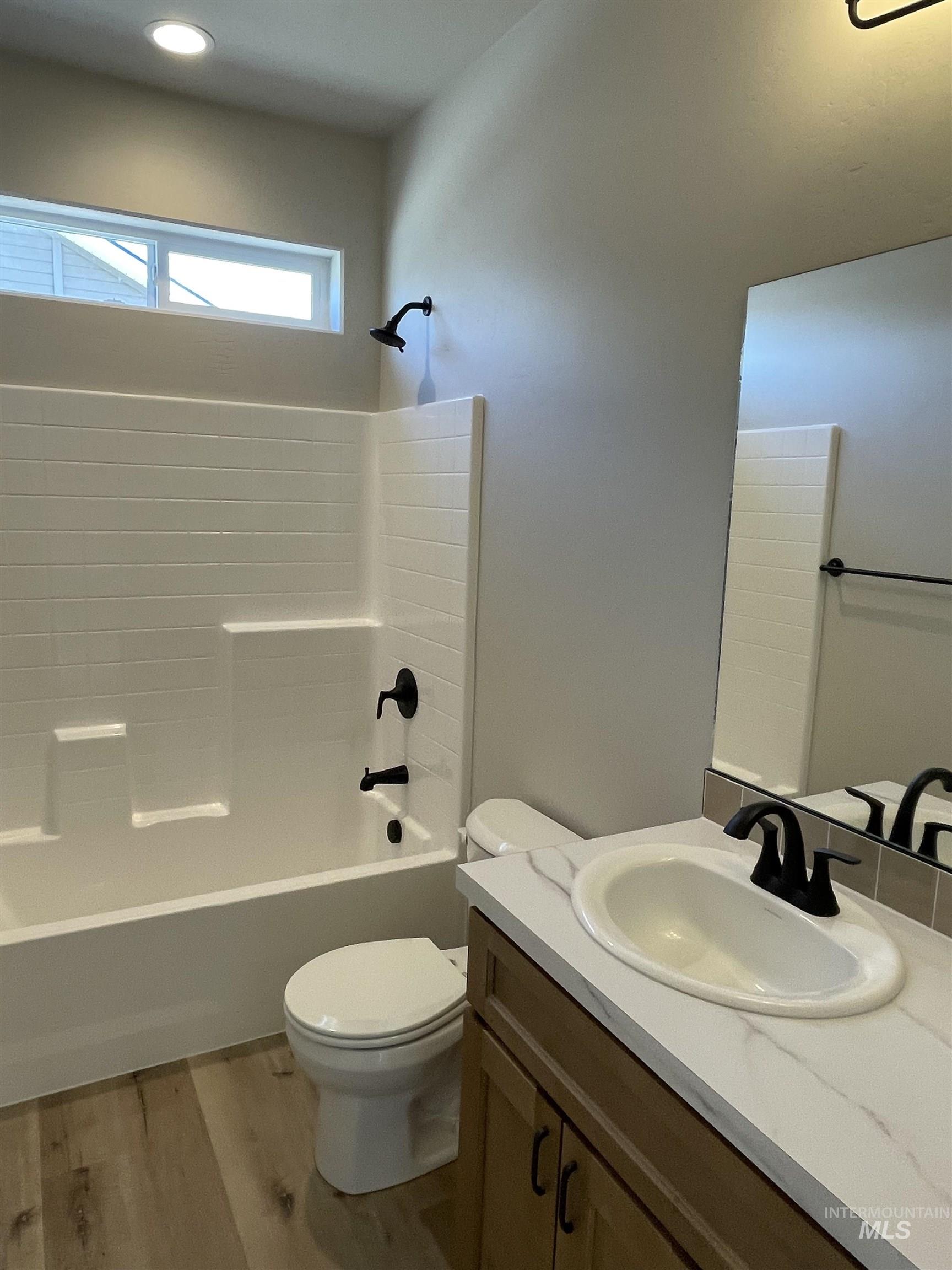 939 Quartz Road Kimberly, ID 83341 - Photo 15 of 18 Full bathroom featuring vanity, shower / washtub combination, and wood finished floors