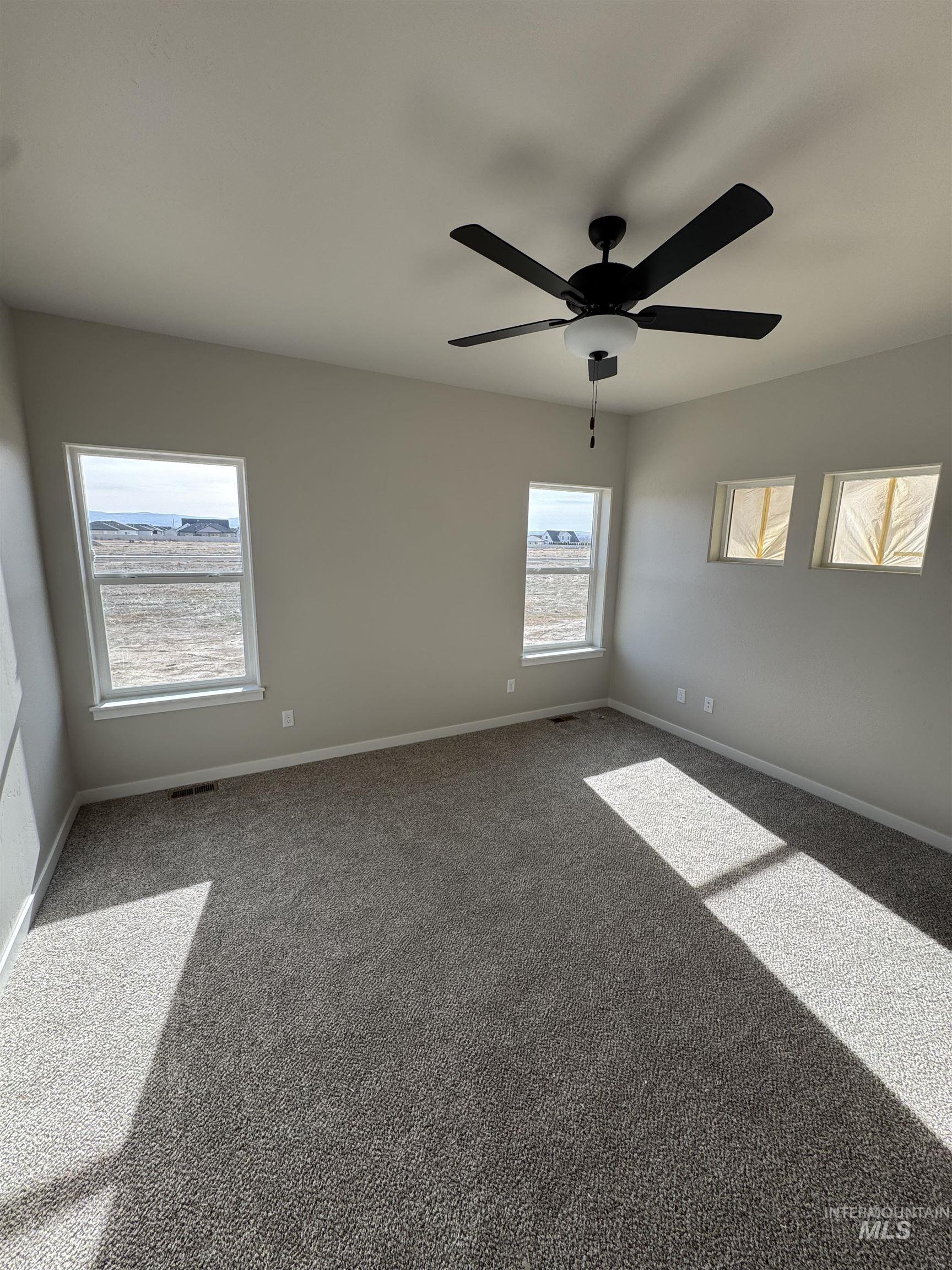 939 Quartz Road Kimberly, ID 83341 - Photo 18 of 18 Carpeted spare room with baseboards and a ceiling fan