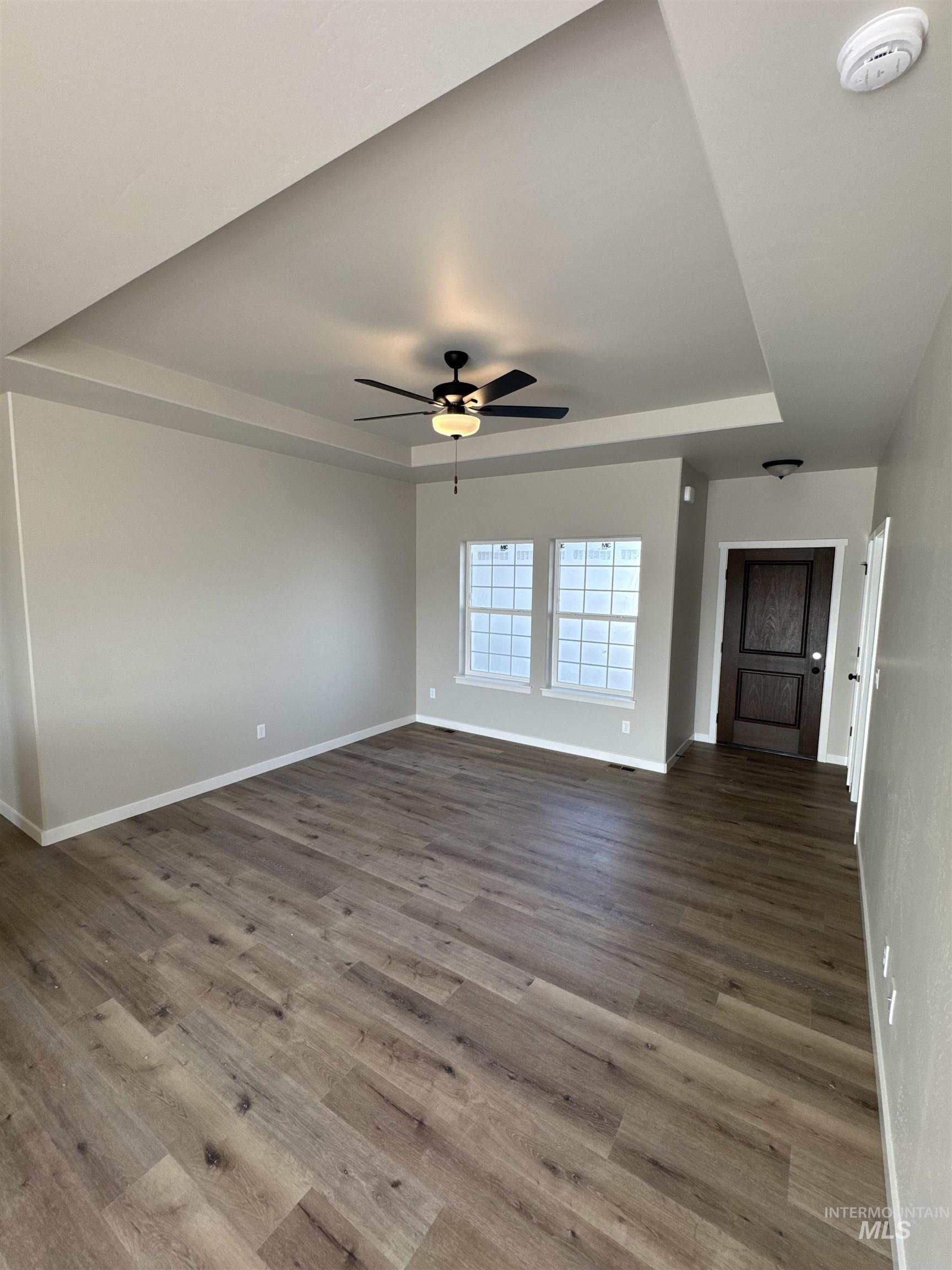 939 Quartz Road Kimberly, ID 83341 - Photo 4 of 18 Unfurnished living room with a raised ceiling, a ceiling fan, and wood finished floors