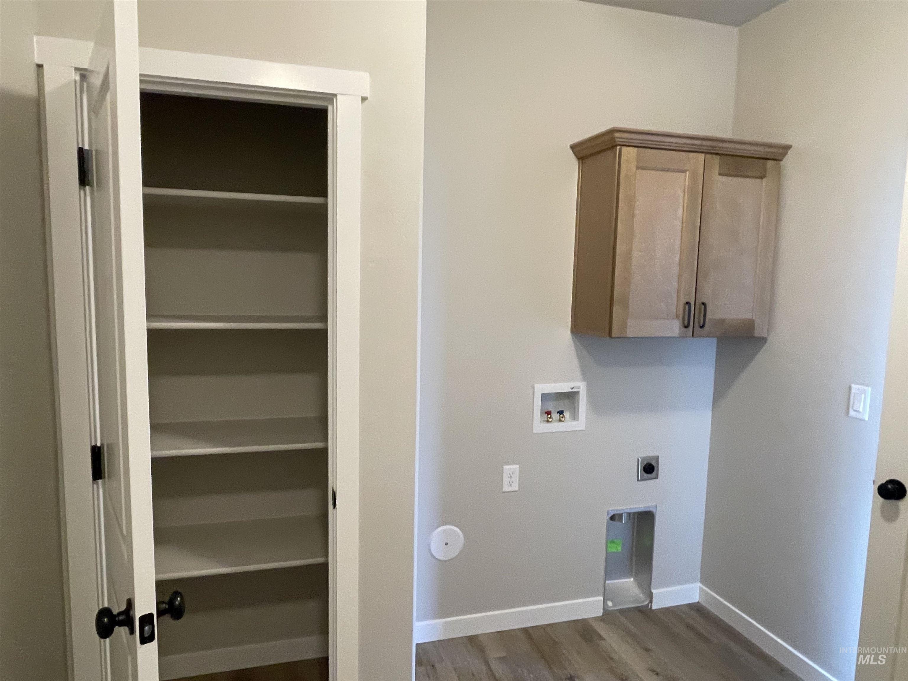 939 Quartz Road Kimberly, ID 83341 - Photo 8 of 18 Laundry room with light wood-style flooring, cabinet space, washer hookup, and hookup for an electric dryer