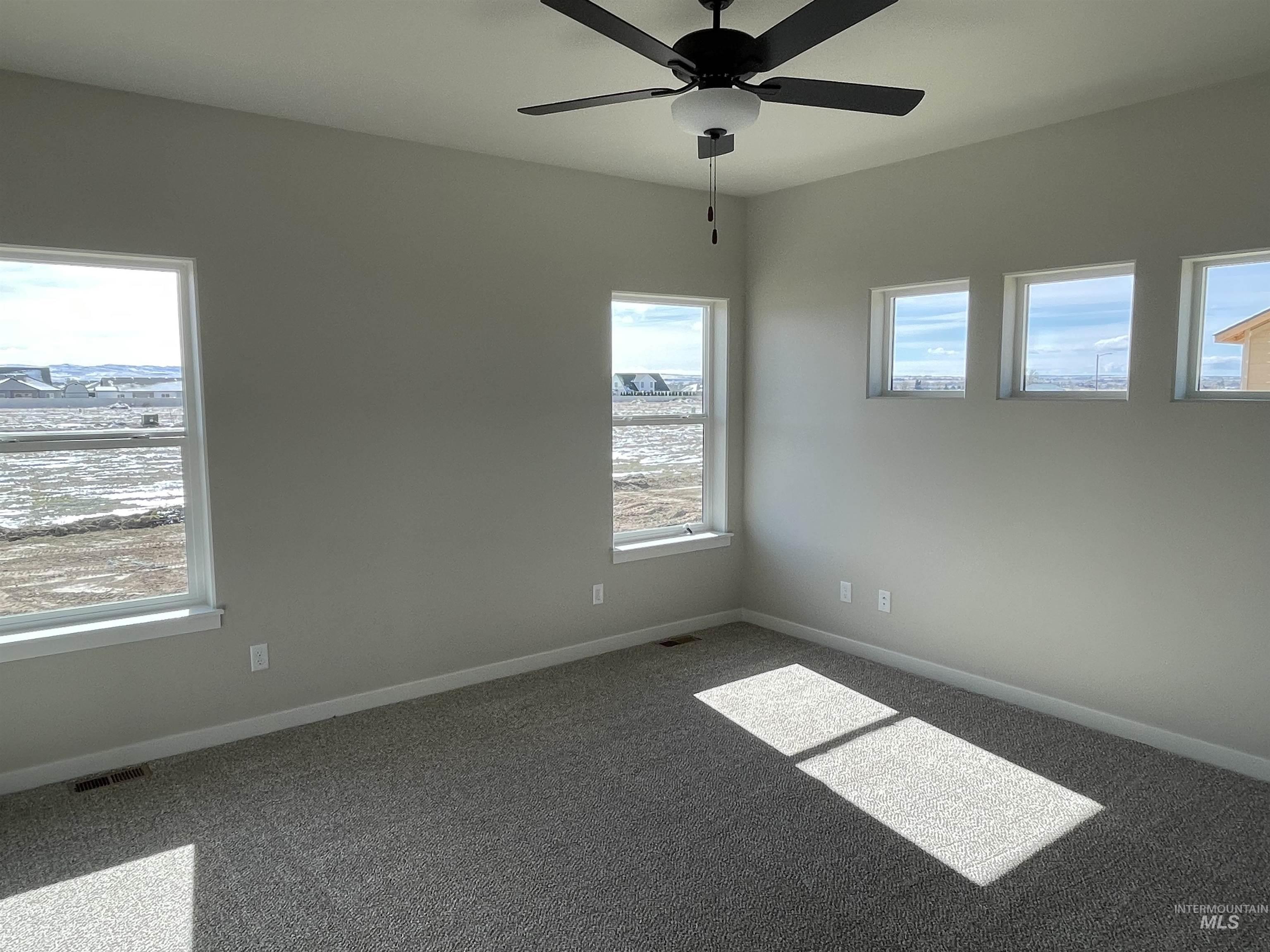939 Quartz Road Kimberly, ID 83341 - Photo 9 of 18 Unfurnished room with carpet floors and a ceiling fan