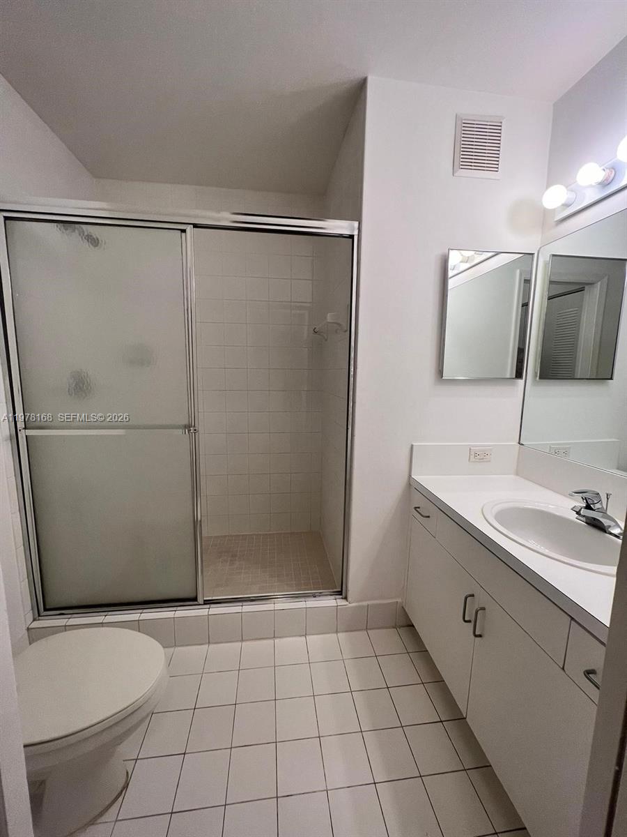 2173 Renaissance Boulevard, Unit 201 Miramar, FL 33025 - Photo 4 of 12 a bathroom with a sink toilet and shower