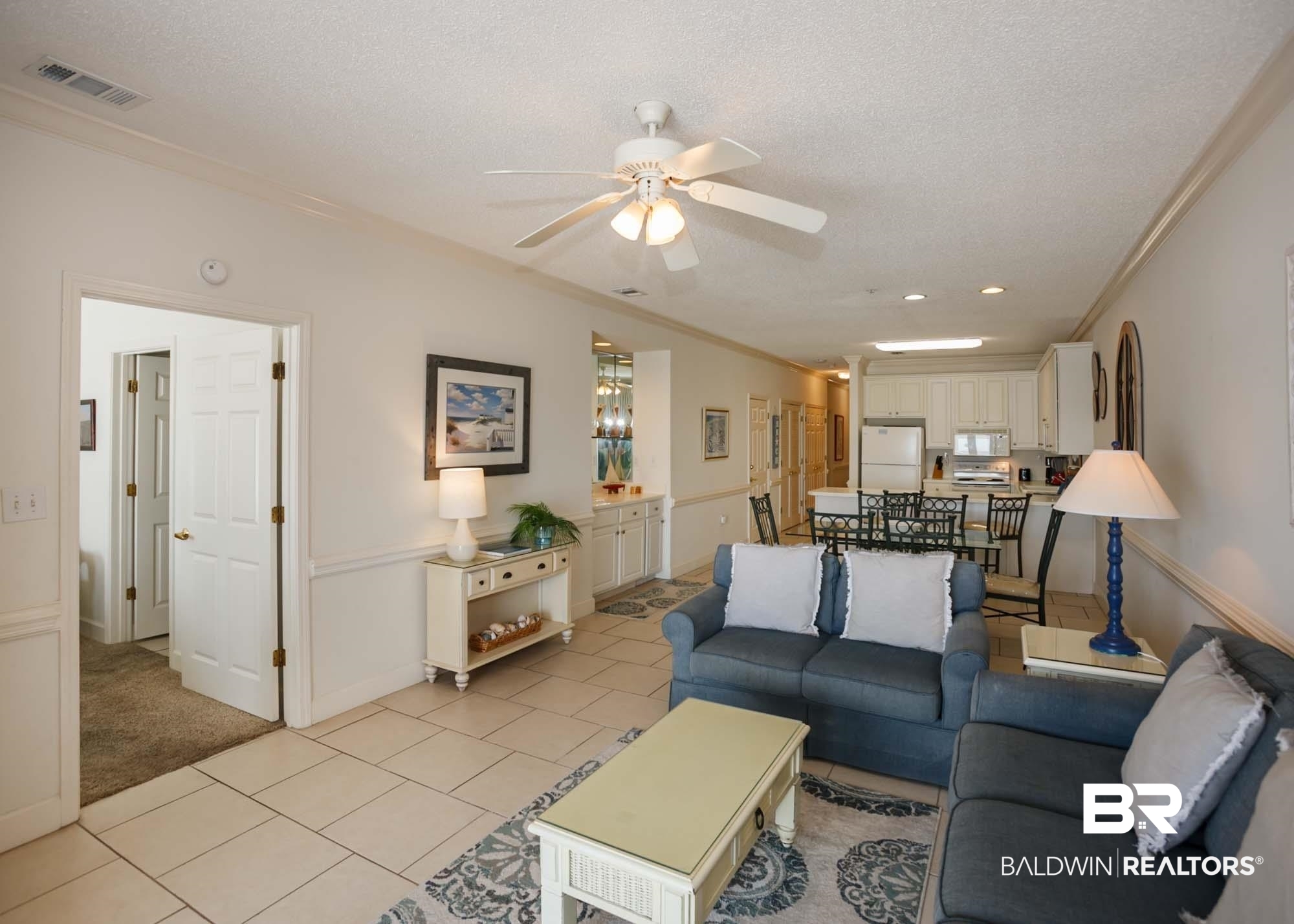 28910 Perdido Beach Boulevard, Unit 4B Orange Beach, AL 36561 - Photo 15 of 48 Living area with a textured ceiling, visible vents, crown molding, and a ceiling fan