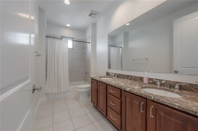 a large bed sitting in a bedroom next to a large window