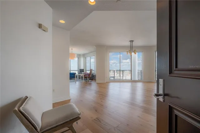 a view of a livingroom with furniture wooden floor and windows