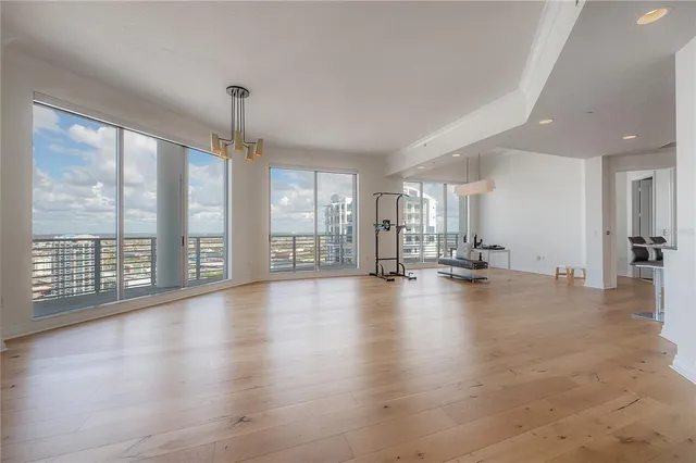 a view of empty room with wooden floor and fireplace