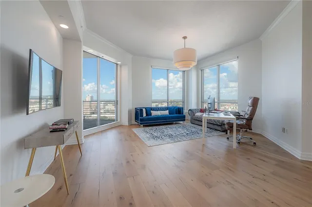 a living room with furniture and a chandelier