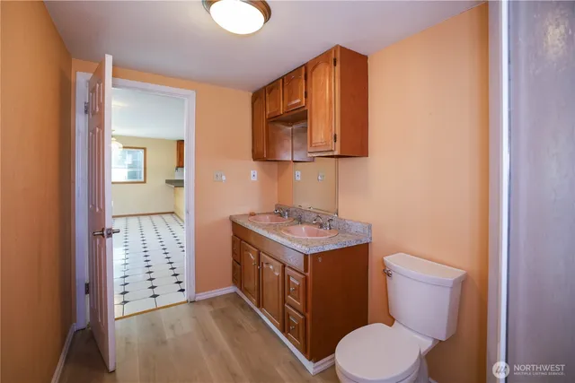 a bathroom with a granite countertop sink toilet and shower