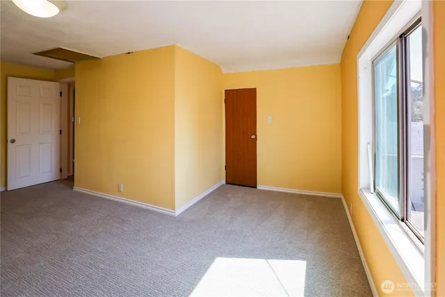a view of a big room with windows and closet