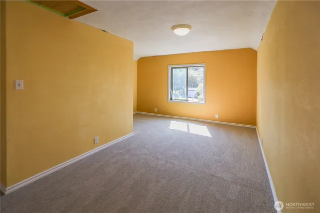 a bedroom with a bed and flat screen tv