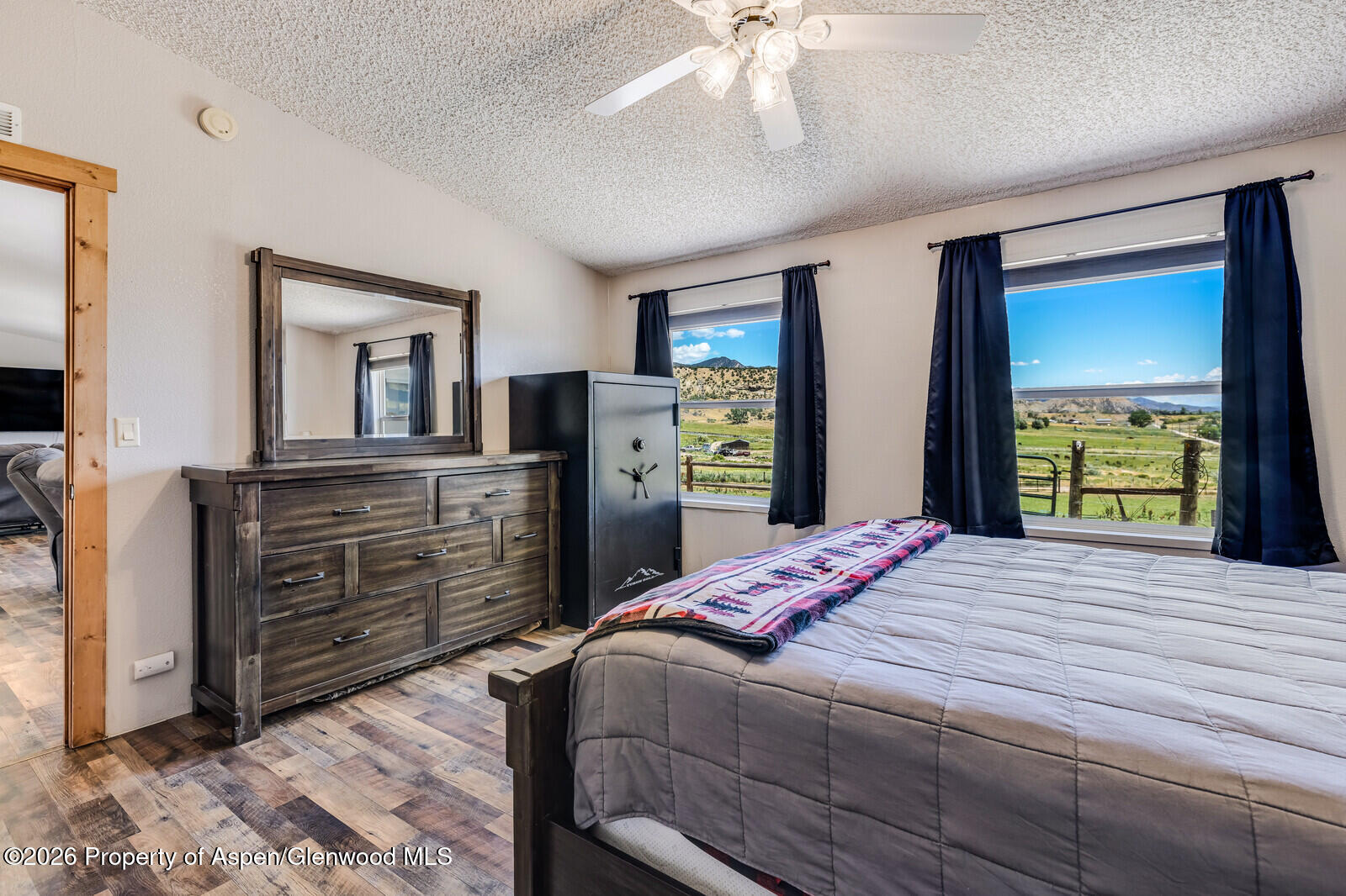 2880 County Road 233 Rifle, CO 81650 - Photo 15 of 47 a bedroom with a bed and a dresser