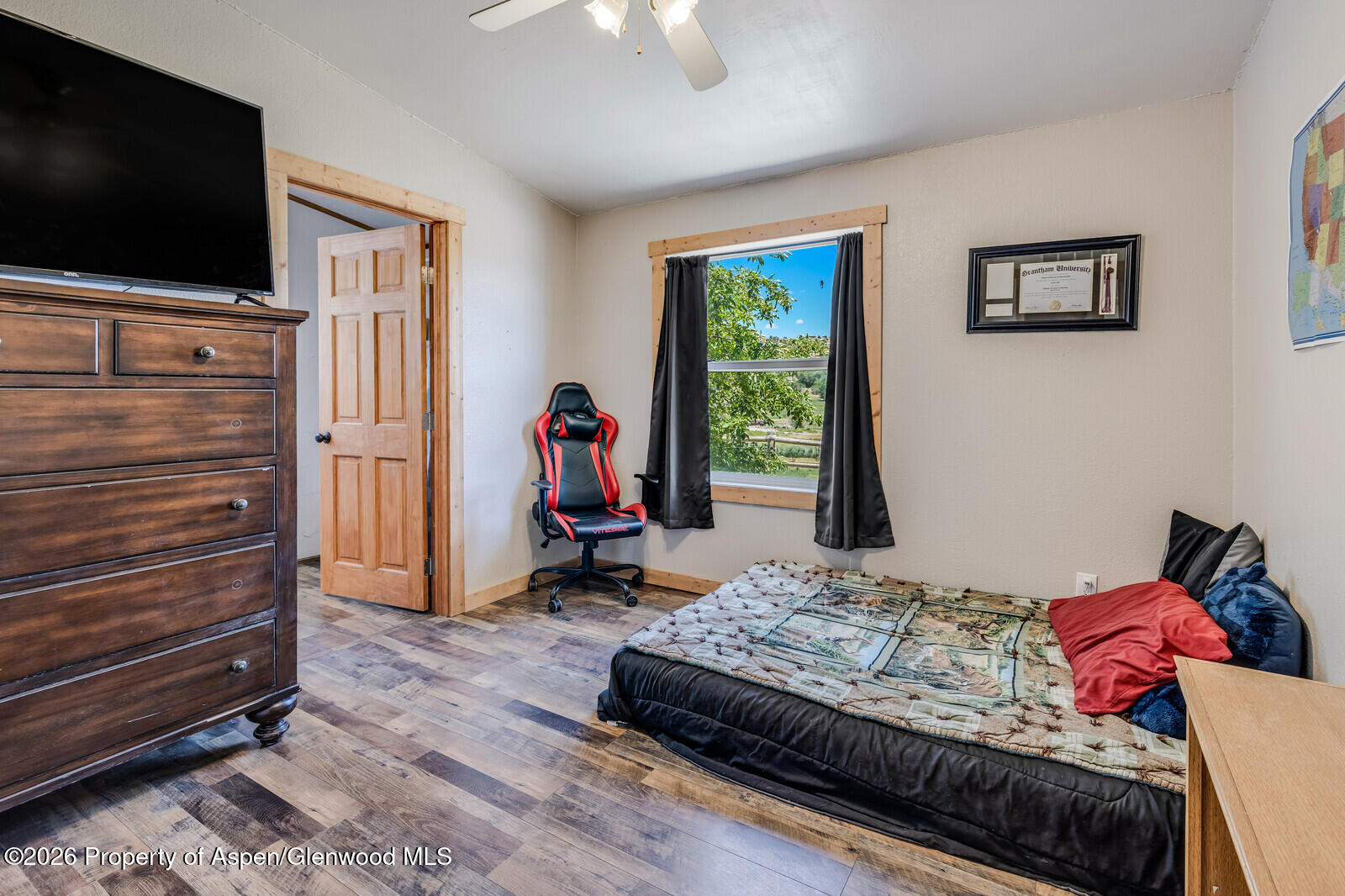 2880 County Road 233 Rifle, CO 81650 - Photo 20 of 47 a bedroom with a bed and a flat screen tv