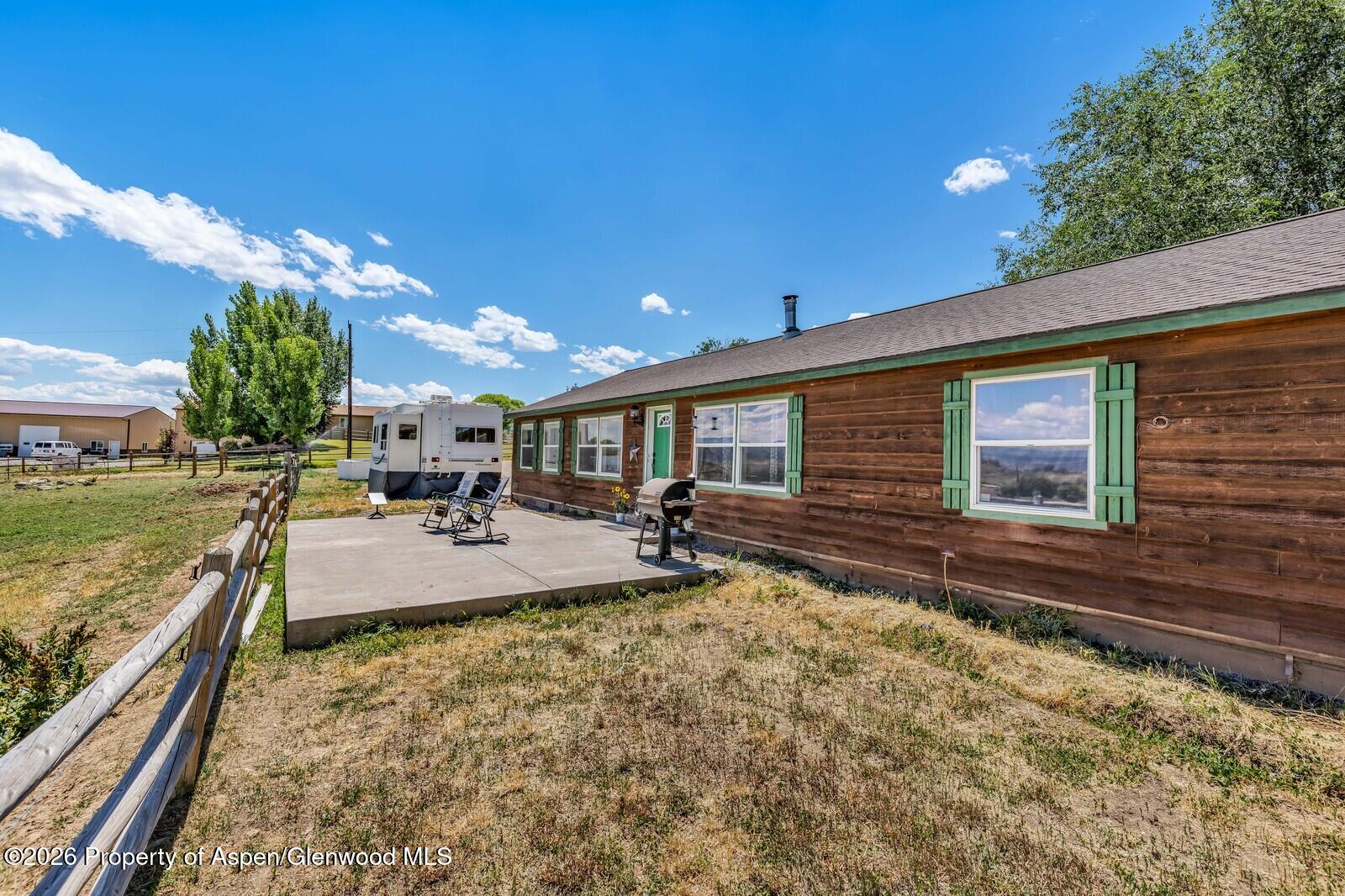 2880 County Road 233 Rifle, CO 81650 - Photo 28 of 47 a swimming pool with outdoor seating and yard