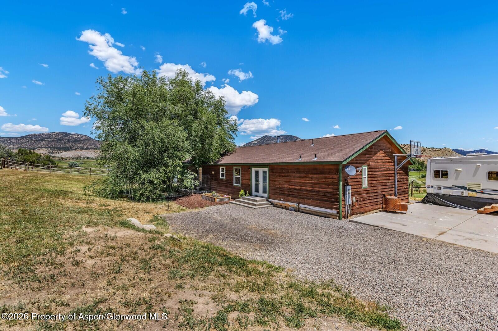 2880 County Road 233 Rifle, CO 81650 - Photo 3 of 47 a view of a house with a yard and potted plants