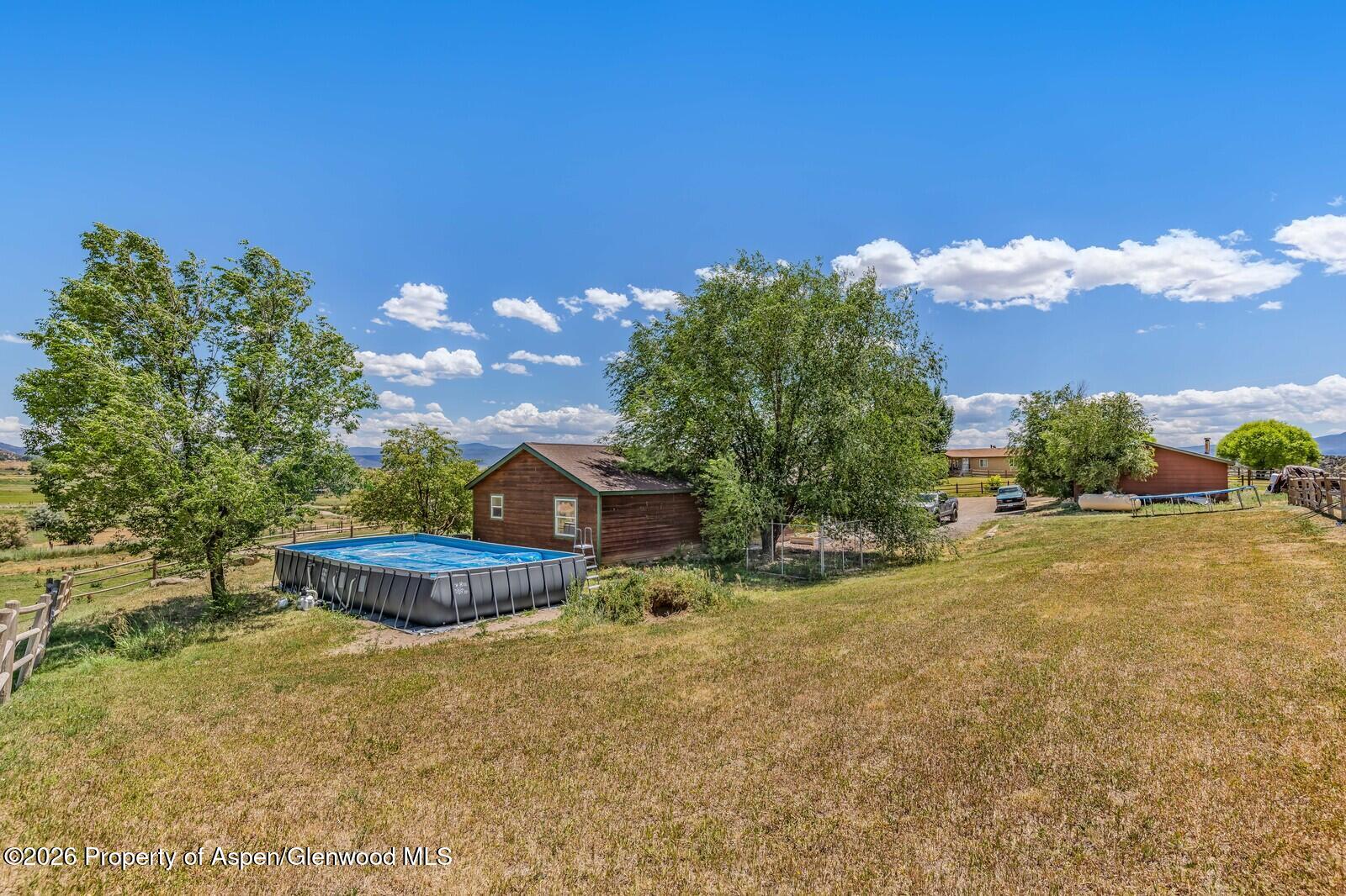 2880 County Road 233 Rifle, CO 81650 - Photo 45 of 47 a view of a backyard with plants and a fountain