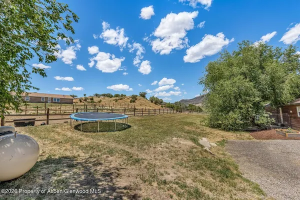 a view of a swimming pool with a yard