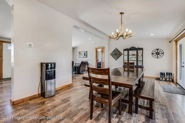 a view of a dining room with furniture and wooden floor