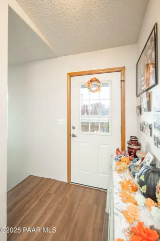a view of a bedroom with wooden floor and a window