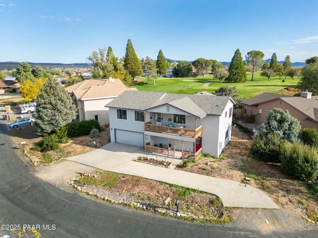 an aerial view of a houses with a swimming pool