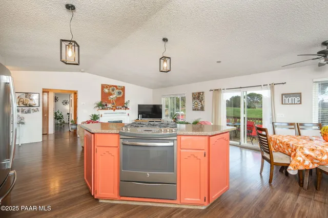 a kitchen with stainless steel appliances granite countertop a stove and cabinets