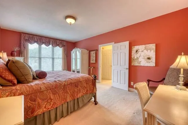 a bedroom with a bed and a table